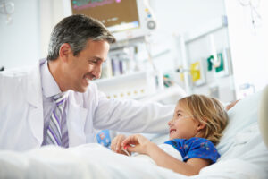 young girl talking to doctor in hospital