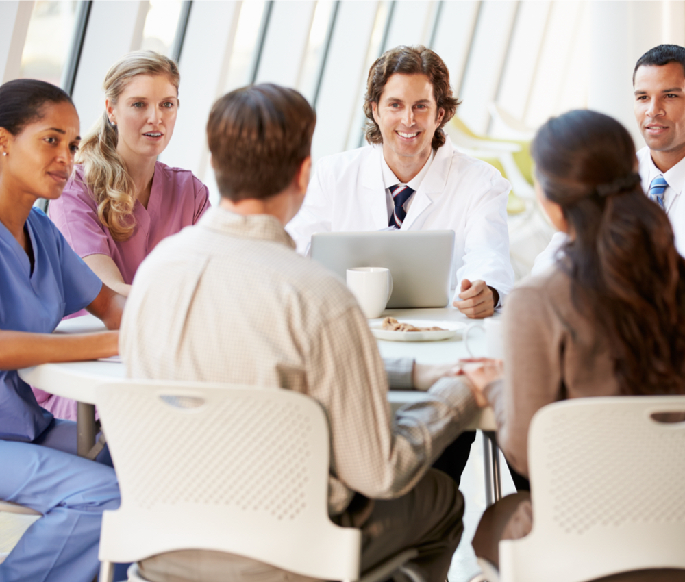 team of professionals sitting around table