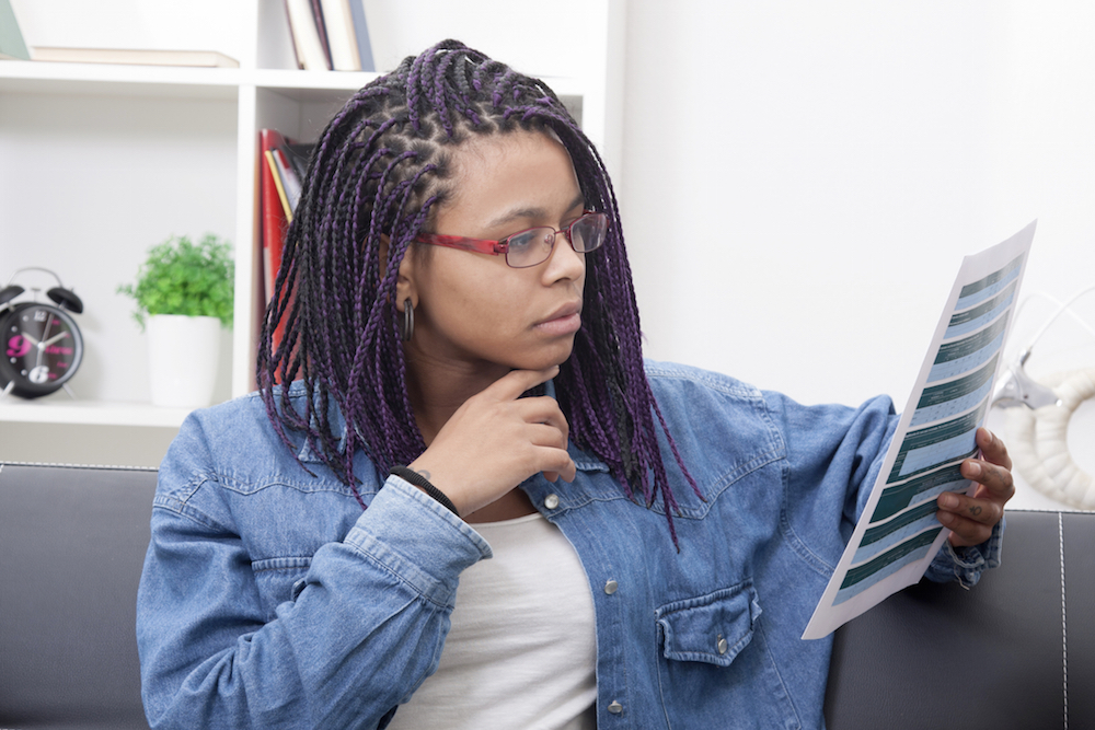 woman reading a laminated sheet