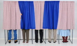 people in voting booths