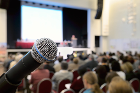Dynamic microphone against the background of convention center