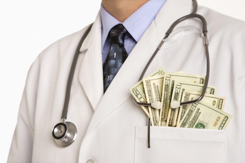 doctor with cash in his lab coat pocket.