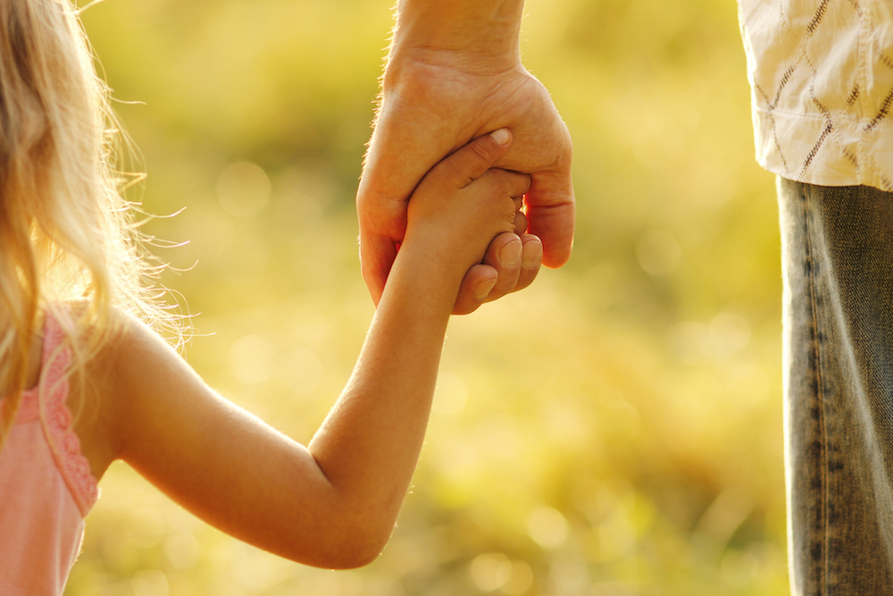 child holding an adult's hand