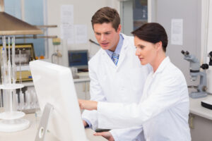 scientists looking attentively at a computer