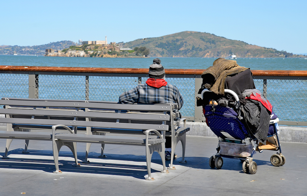 homeless man sitting by the bay in San Francisco.