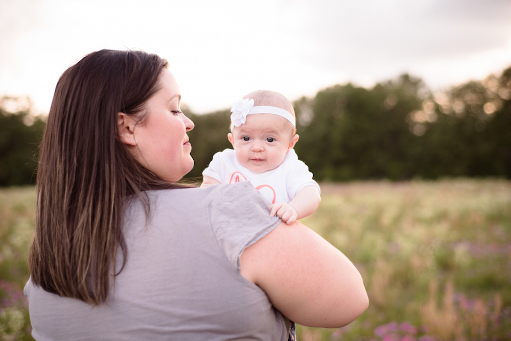 mother holding happy baby