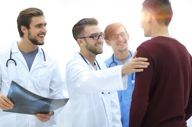 doctors congratulate patient on recovery
