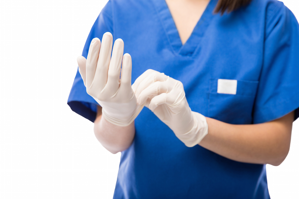 Nurse putting on gloves