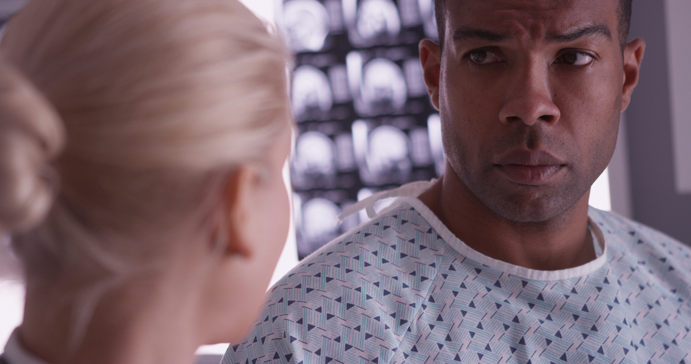 black patient talking to a white doctor