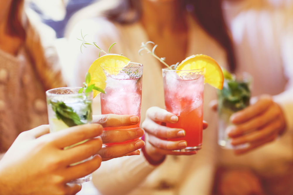 women toasting with cocktails.