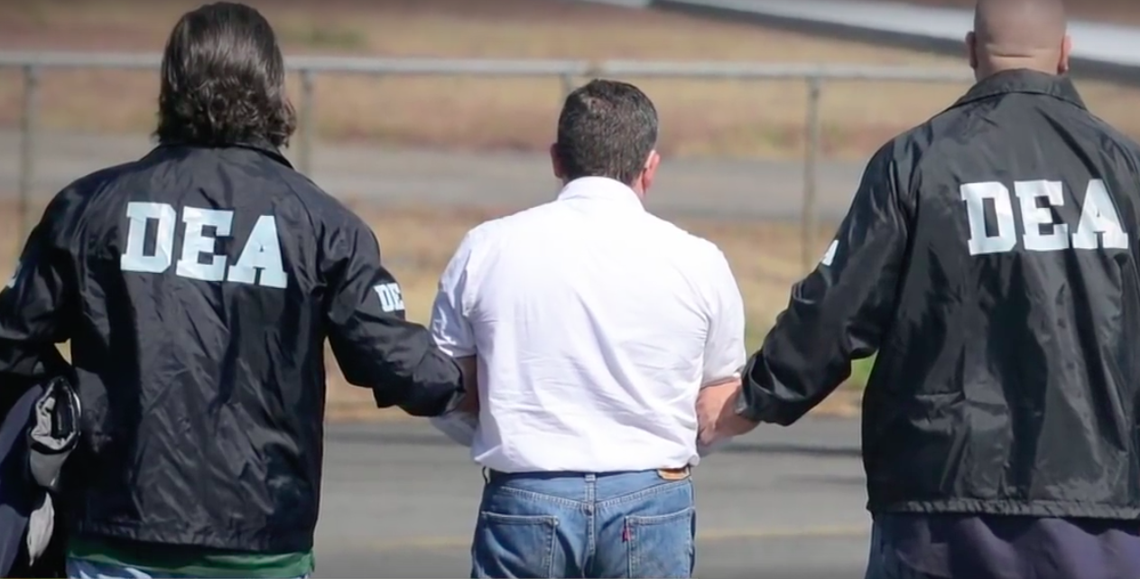 DEA agents escorting a suspect