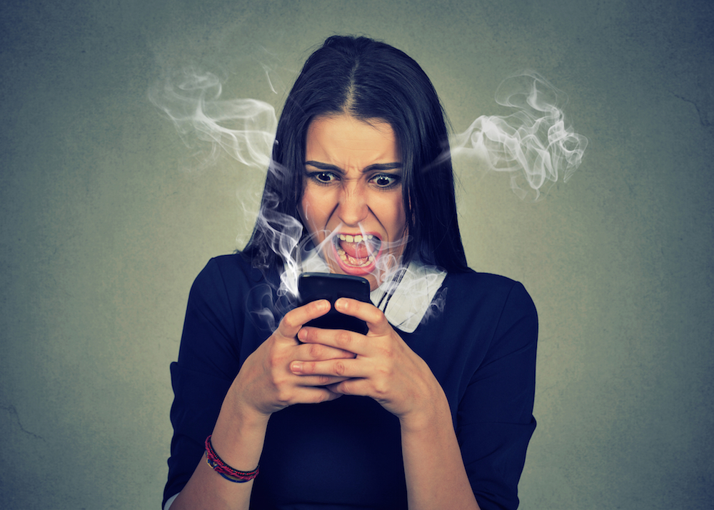 woman angrily using her cellphone
