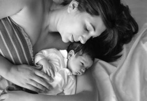 mother lying with her newborn