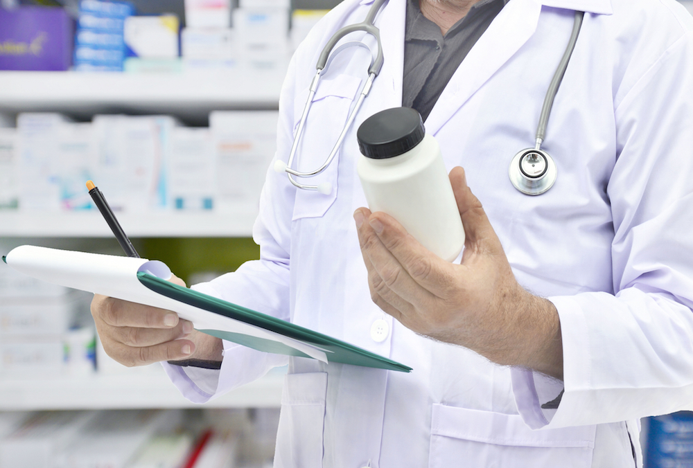 pharmacist holding a prescription bottle