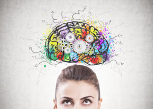 Woman with a brain illustration drawn over her head.