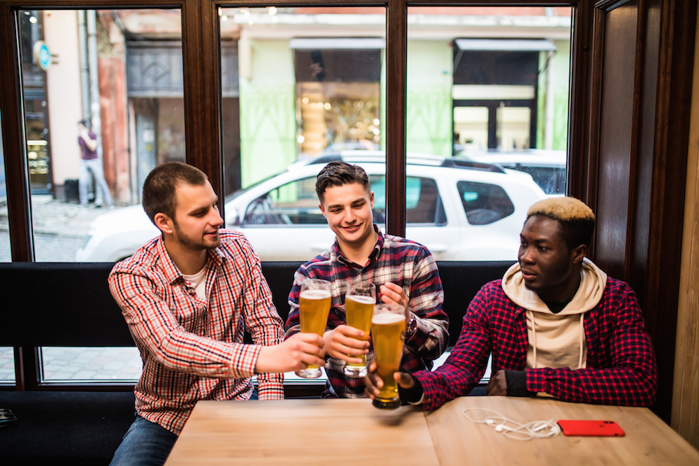 men toasting with big beer glasses