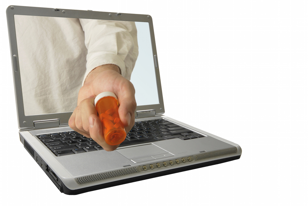 hand offering prescription through laptop screen