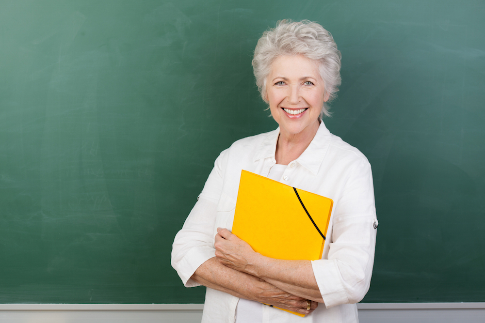 teacher standing in front of chalkboard