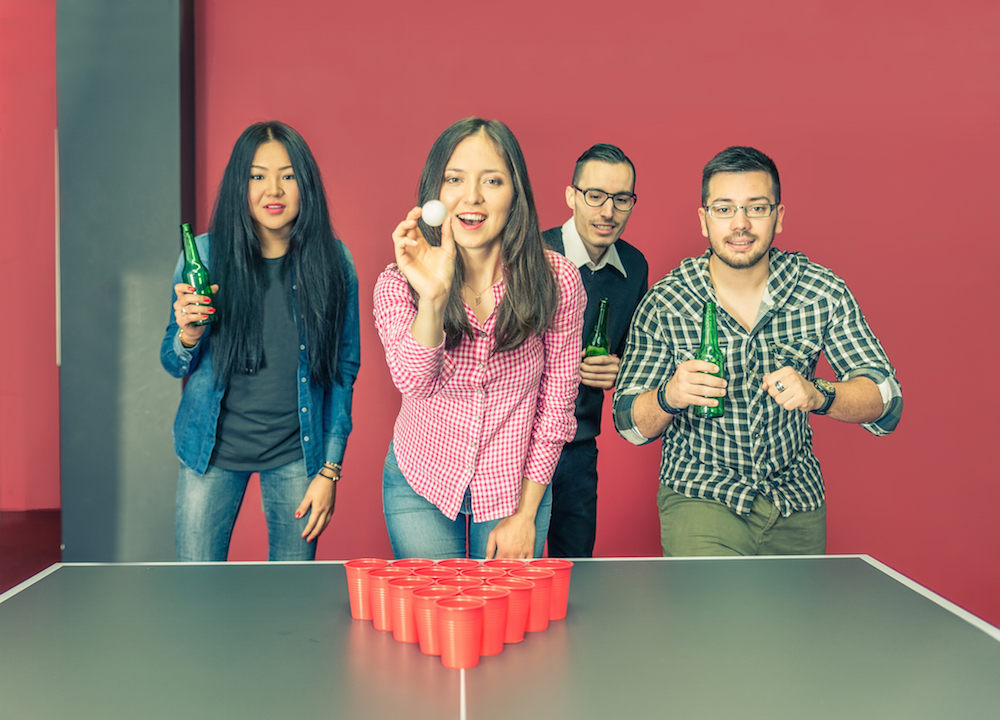 group of students playing beer pong