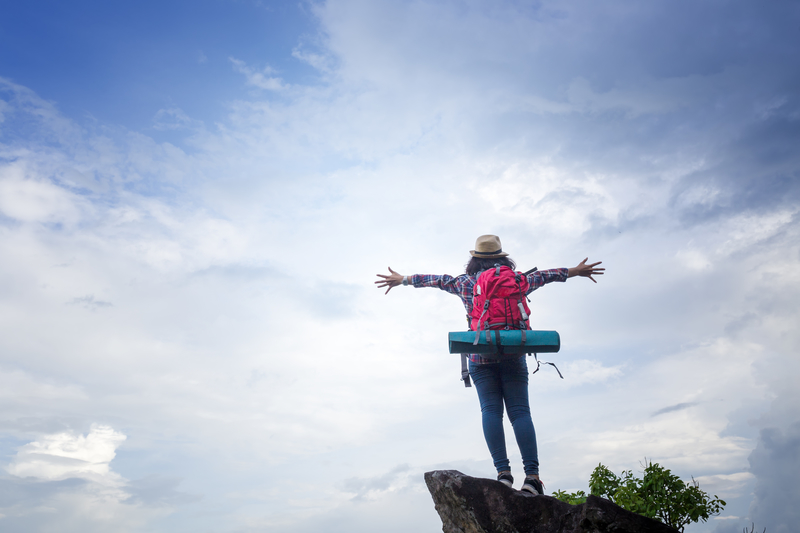 girl spreading arms on top of mountain, okay after leaving a 12-step fellowship.