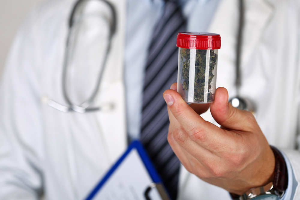 doctor holding a medical marijuana prescription bottle in Oregon