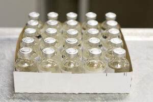 a box of naloxone vials on a pharmacy counter.