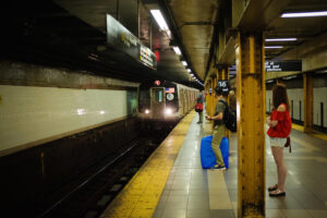 New York residents waiting on the subway platform for a train in need of repairs