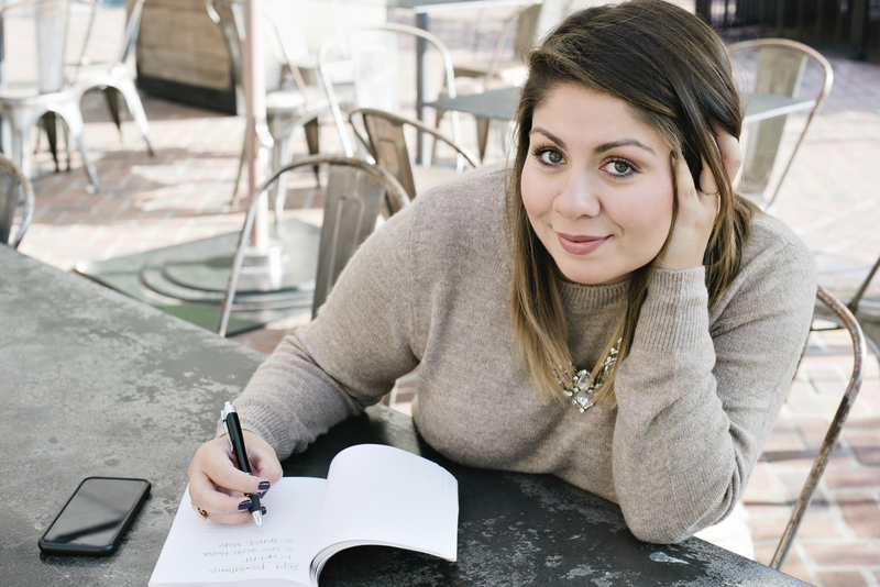 Woman sits and writes in a journal, taking stock of recovery