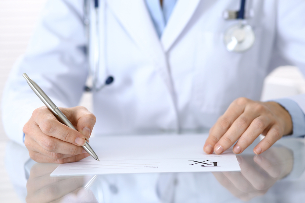 doctor writing prescription
