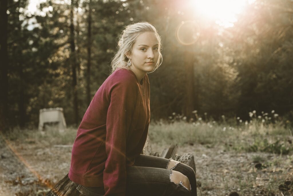 Microdosing Marijuana at 9 Years Sober Woman sitting outdoors, thinking about microdosing marijuana