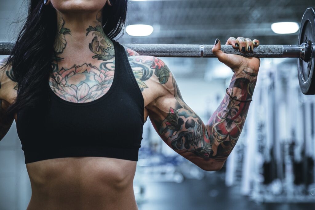Exercise: Making Amends to Your Body Torso and arm of woman lifting weights, exercising in recovery, making amends to her body