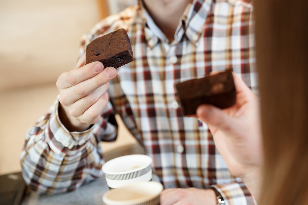 man holding an edible brownie infused with CBD