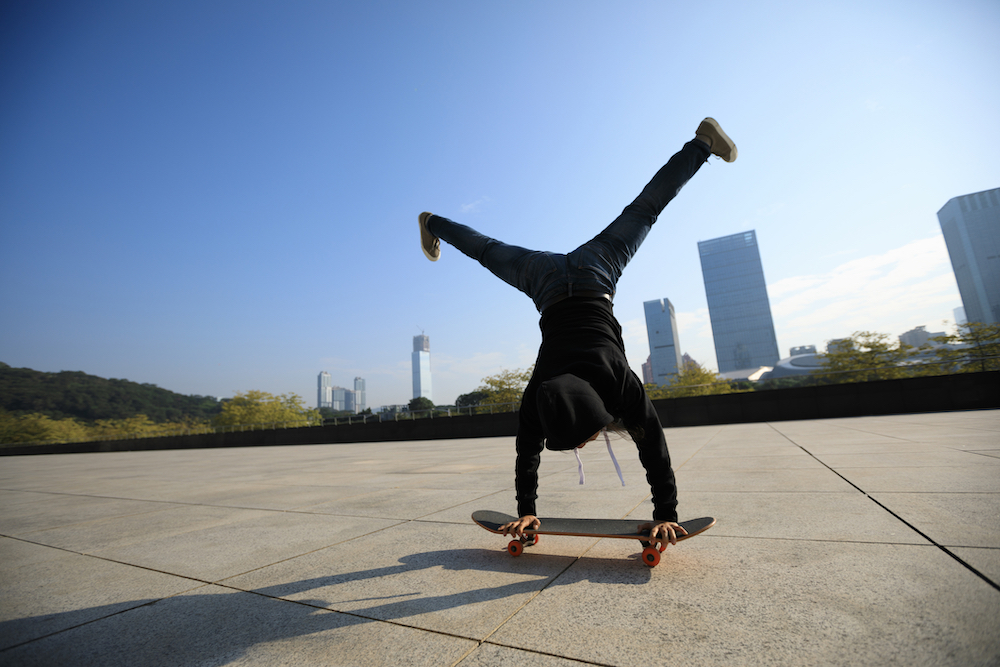 person riding skateboard on hands