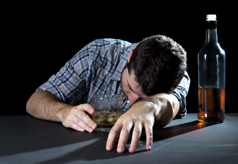 Man with alcohol bottle passed out, with wet brain disease, alcohol-related demential