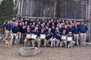 Group of smiling men in blue shirts, Recovery Ranch sober living for men