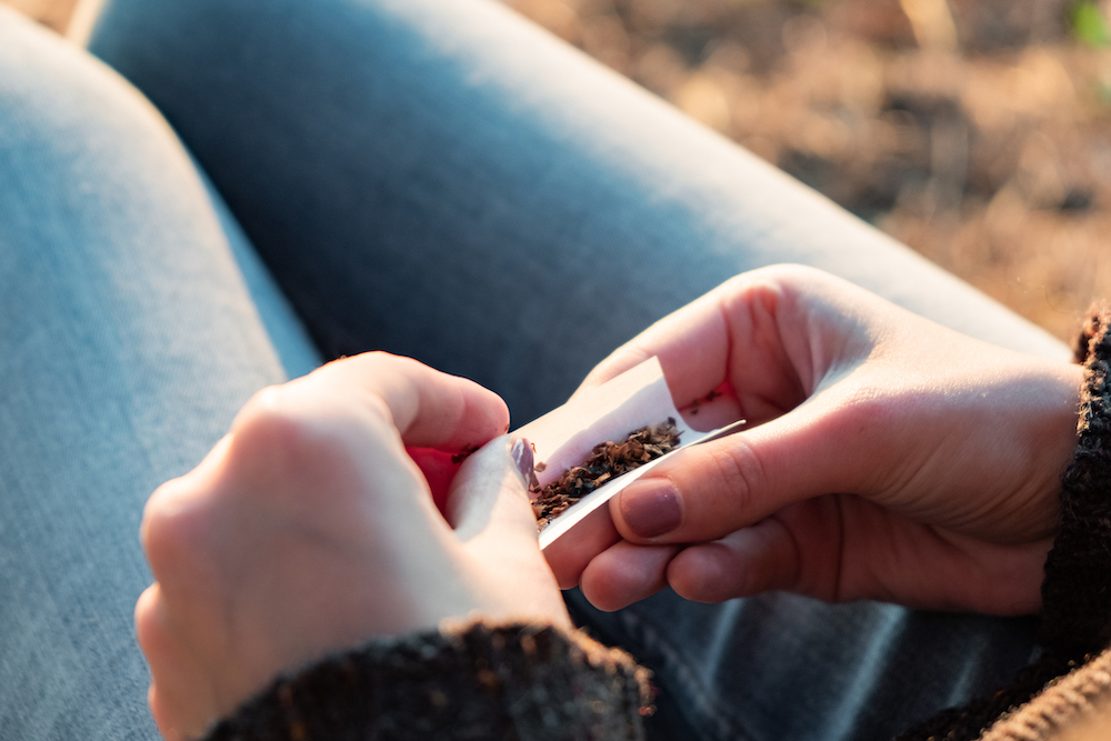 person rolling a medical marijuana joint