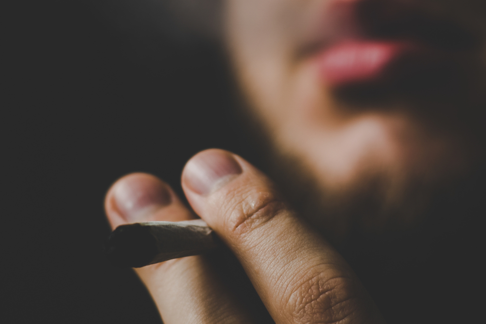person smoking black market cannabis
