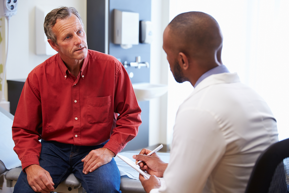 sober man talking to doctor about health damage from addiction