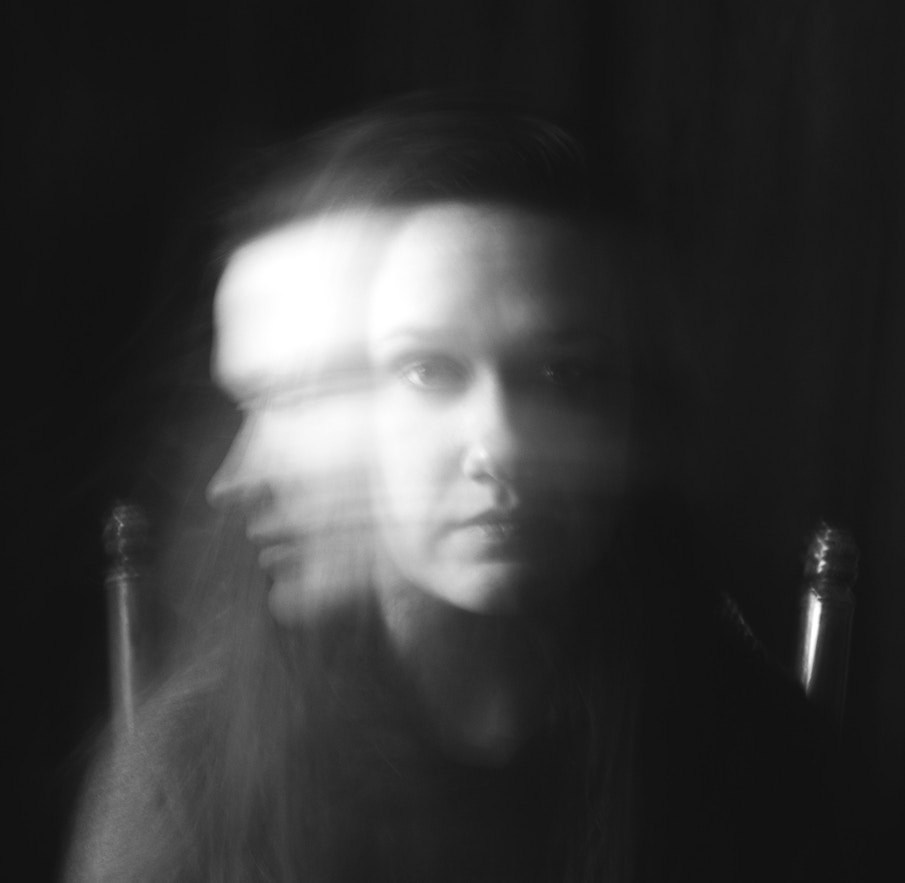 Woman's face, blurry, recovering enabler recognizing trauma.