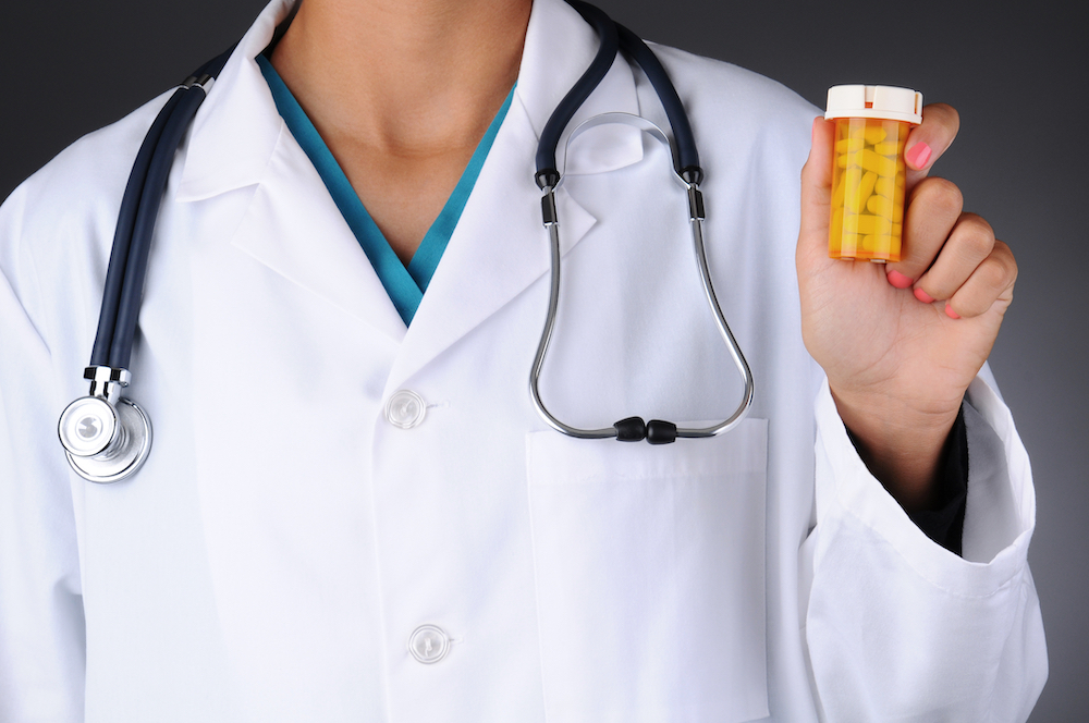 doctor preparing to steal a bottle of prescription opioids