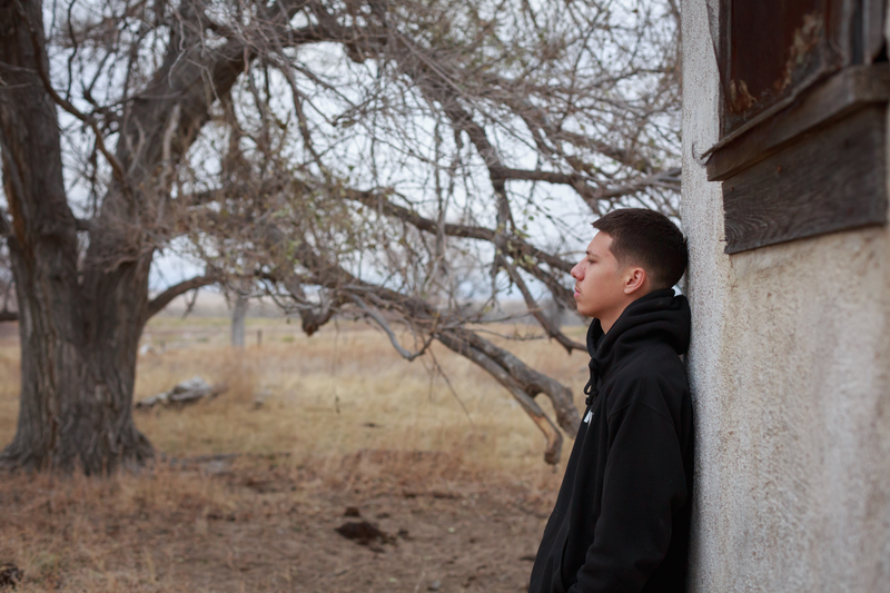 brooding teen boy suffering from co-occurring disorders