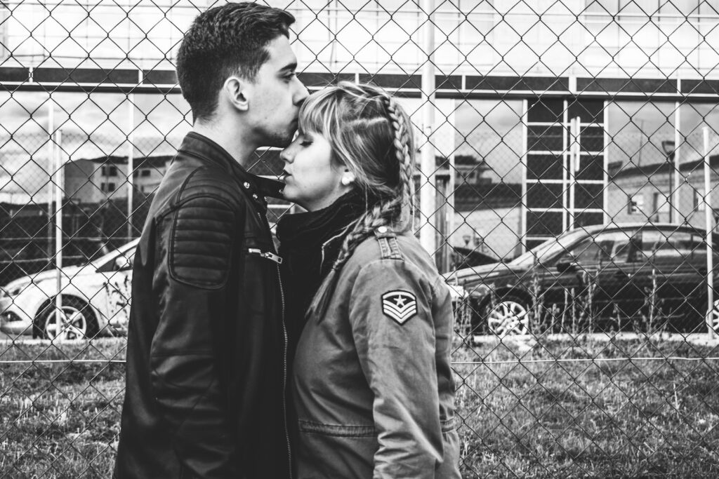 The Magic and the Tragic: Falling in Love in Recovery black and white image of man and woman standing facing each other, close, in love, man kissing woman's forehead