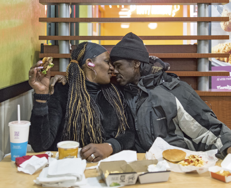 Couple at McDonald's, heads together