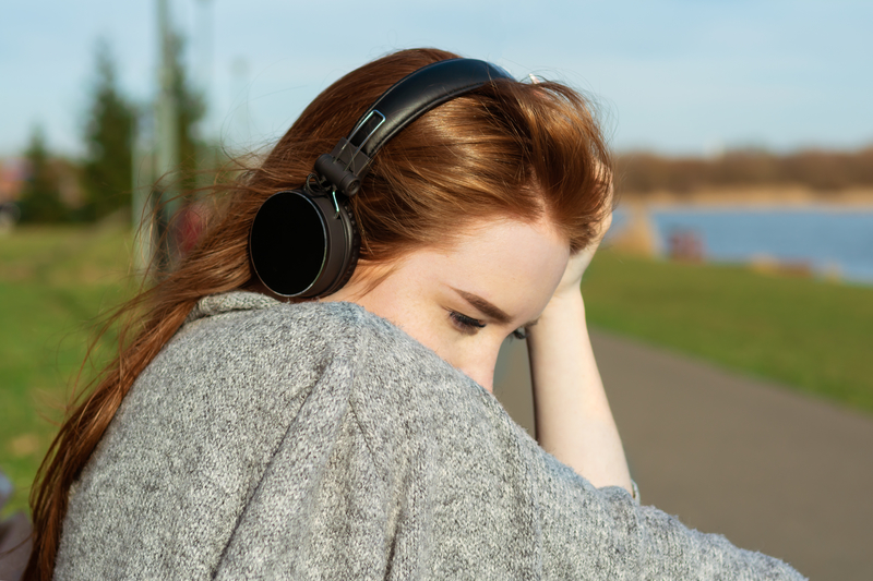 Woman with headphones, listening to music, emotional reaction