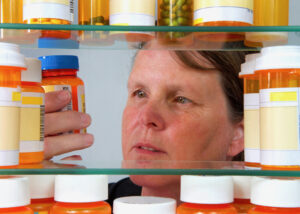 person looking through opioid prescriptions
