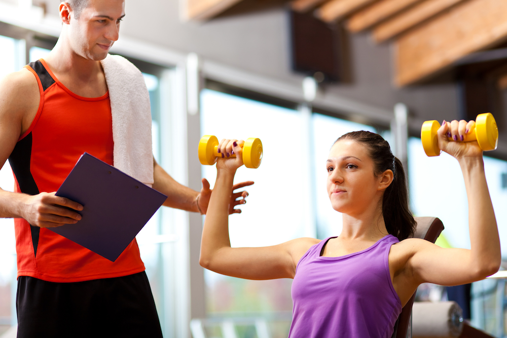personal trainer helping client