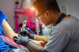 tattoo artist working on client with mental health issues