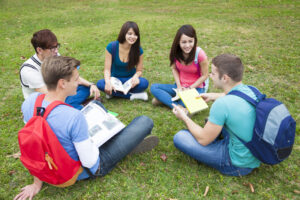sober college students seated in a circle on the grass
