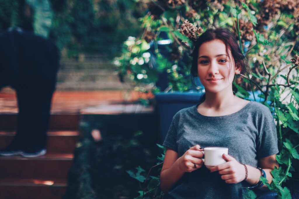 Woman with content expression, outside, observing without a smartphone