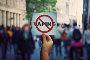 person holding up no vaping sign in Massachusetts
